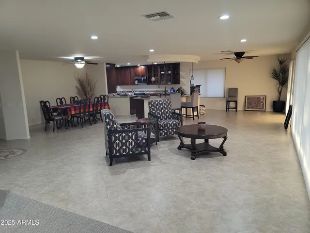 a view of a dining room with furniture and a potted plant