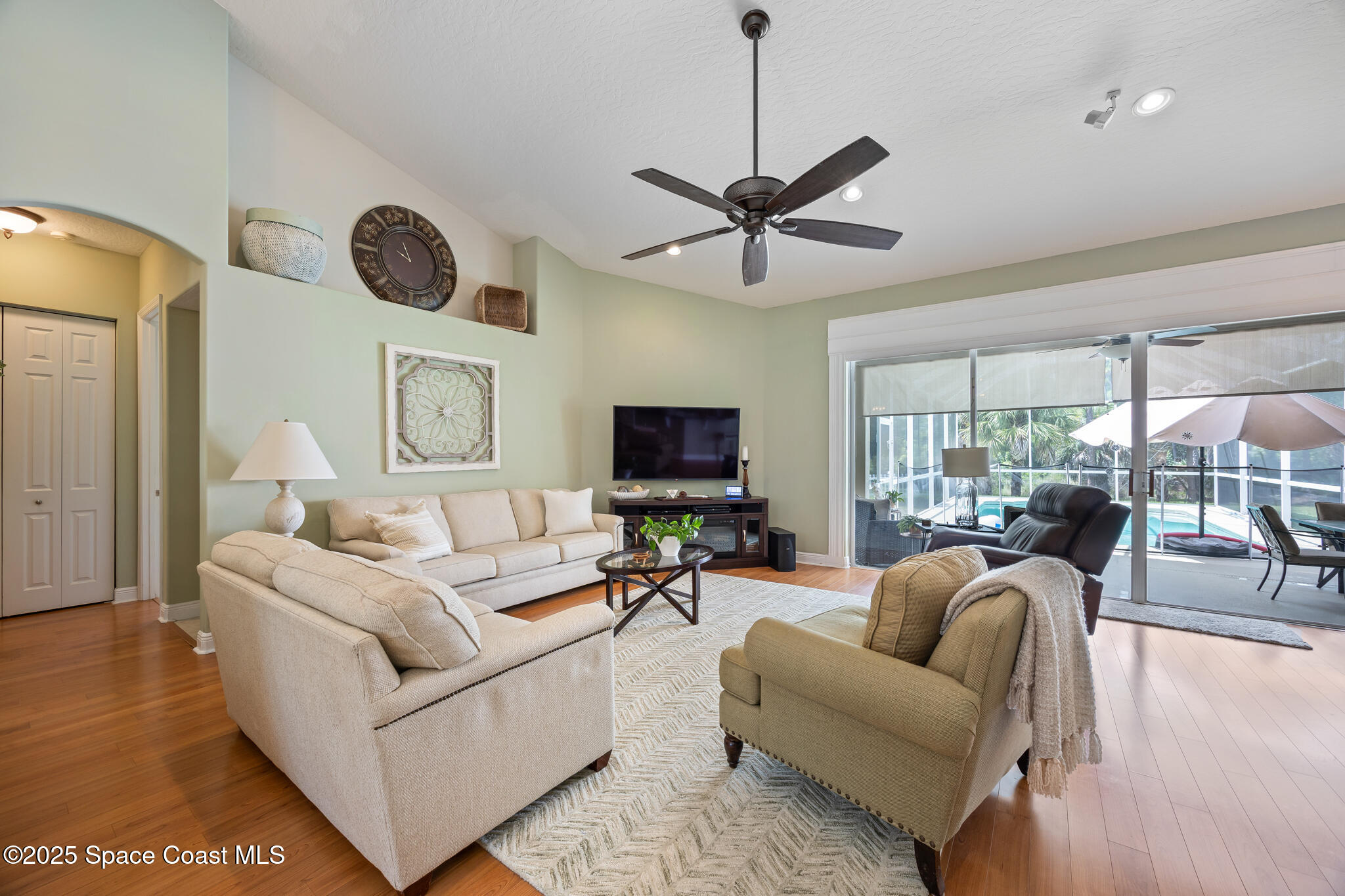 7210 Wando Avenue Grant, FL 32949 - Photo 11 of 41 a living room with furniture a ceiling fan and a large window
