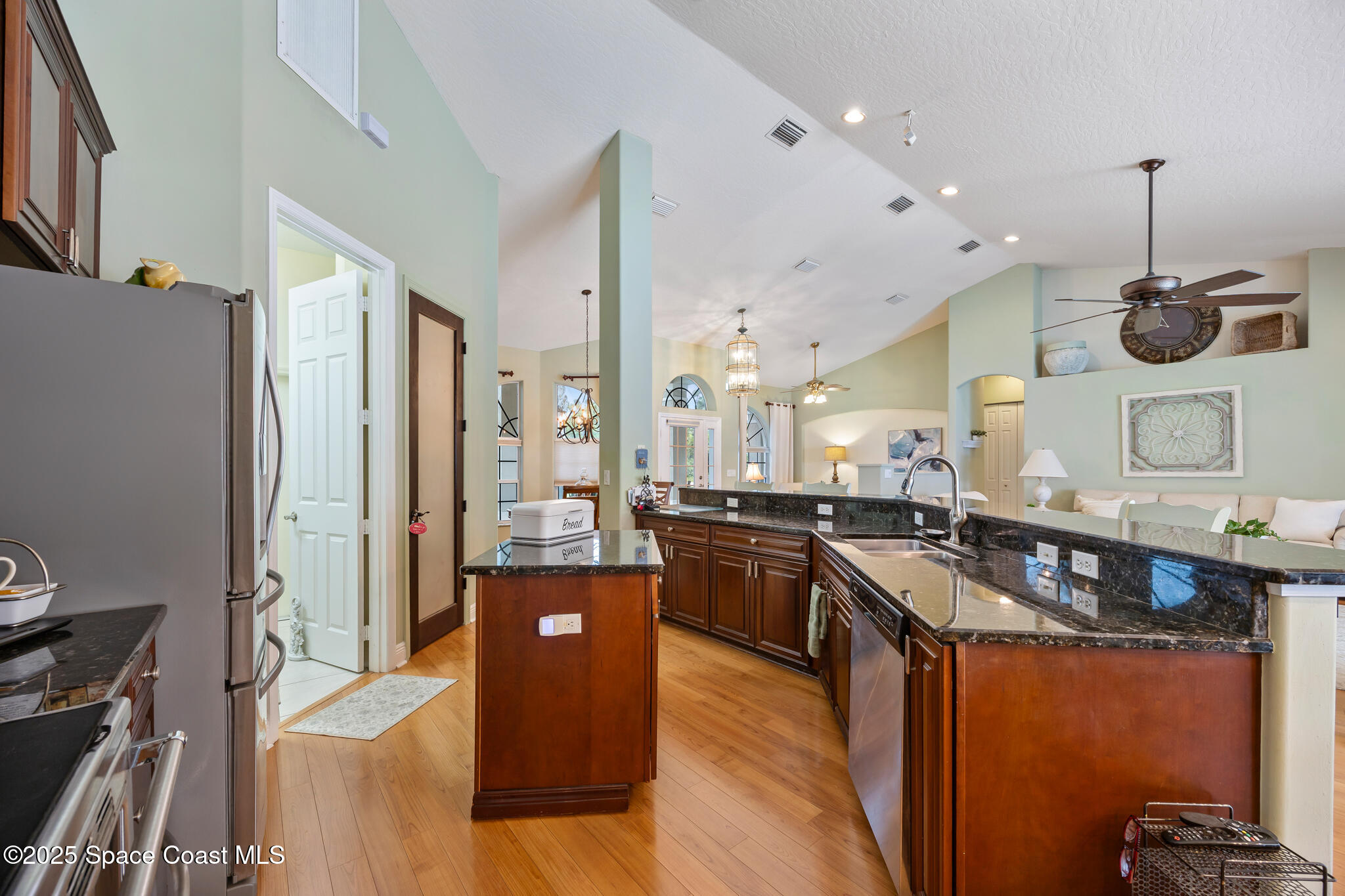 7210 Wando Avenue Grant, FL 32949 - Photo 14 of 41 a kitchen with granite countertop a sink a counter top space stove and cabinets