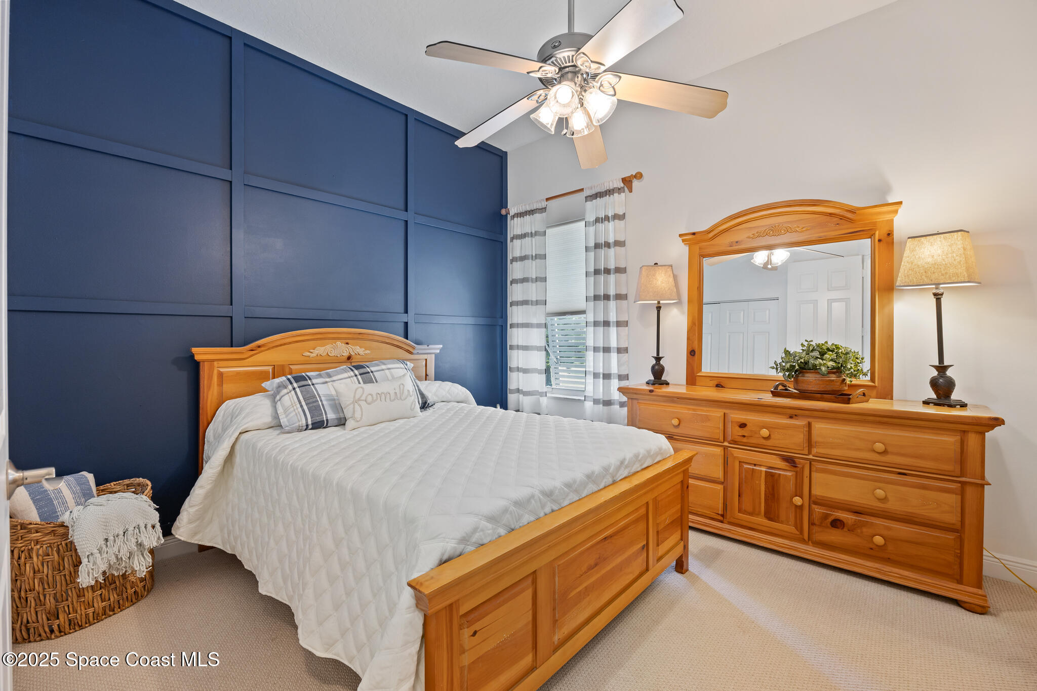 7210 Wando Avenue Grant, FL 32949 - Photo 17 of 41 a bedroom with a bed and a chandelier