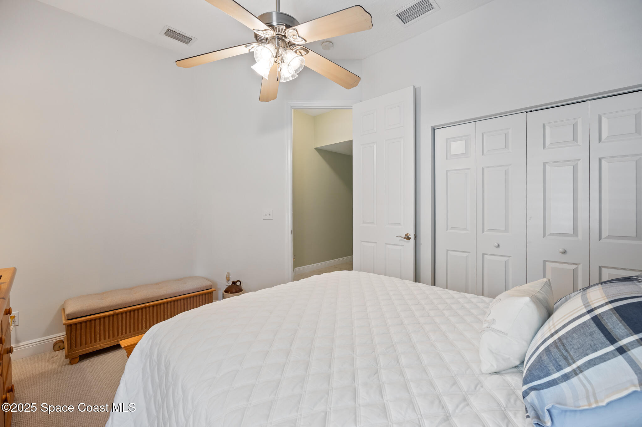 7210 Wando Avenue Grant, FL 32949 - Photo 18 of 41 a bedroom with a bed and a chandelier