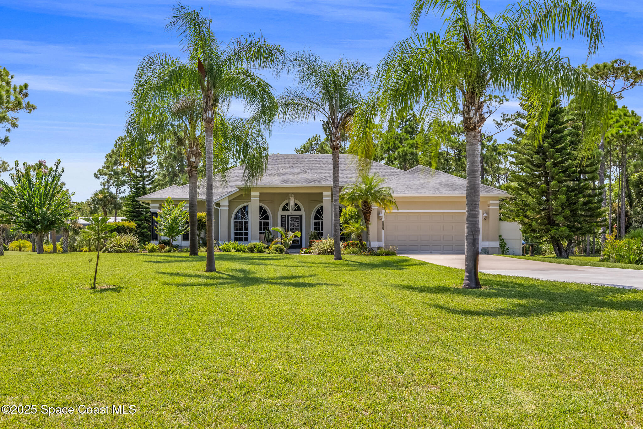 7210 Wando Avenue Grant, FL 32949 - Photo 2 of 41 a front view of a house with a yard