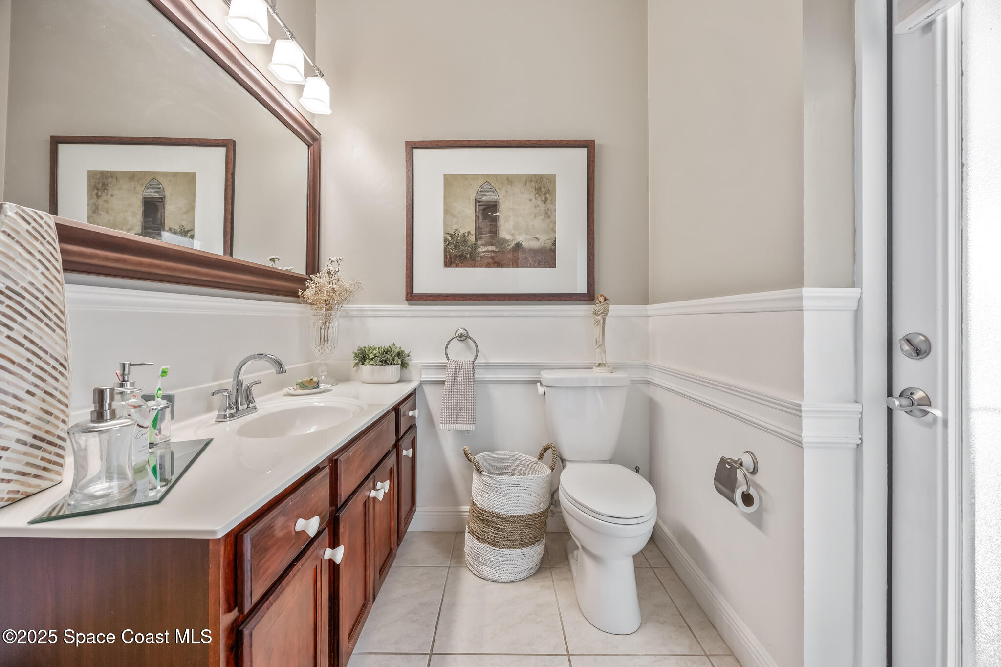 7210 Wando Avenue Grant, FL 32949 - Photo 22 of 41 a bathroom with a granite countertop sink mirror vanity and toilet