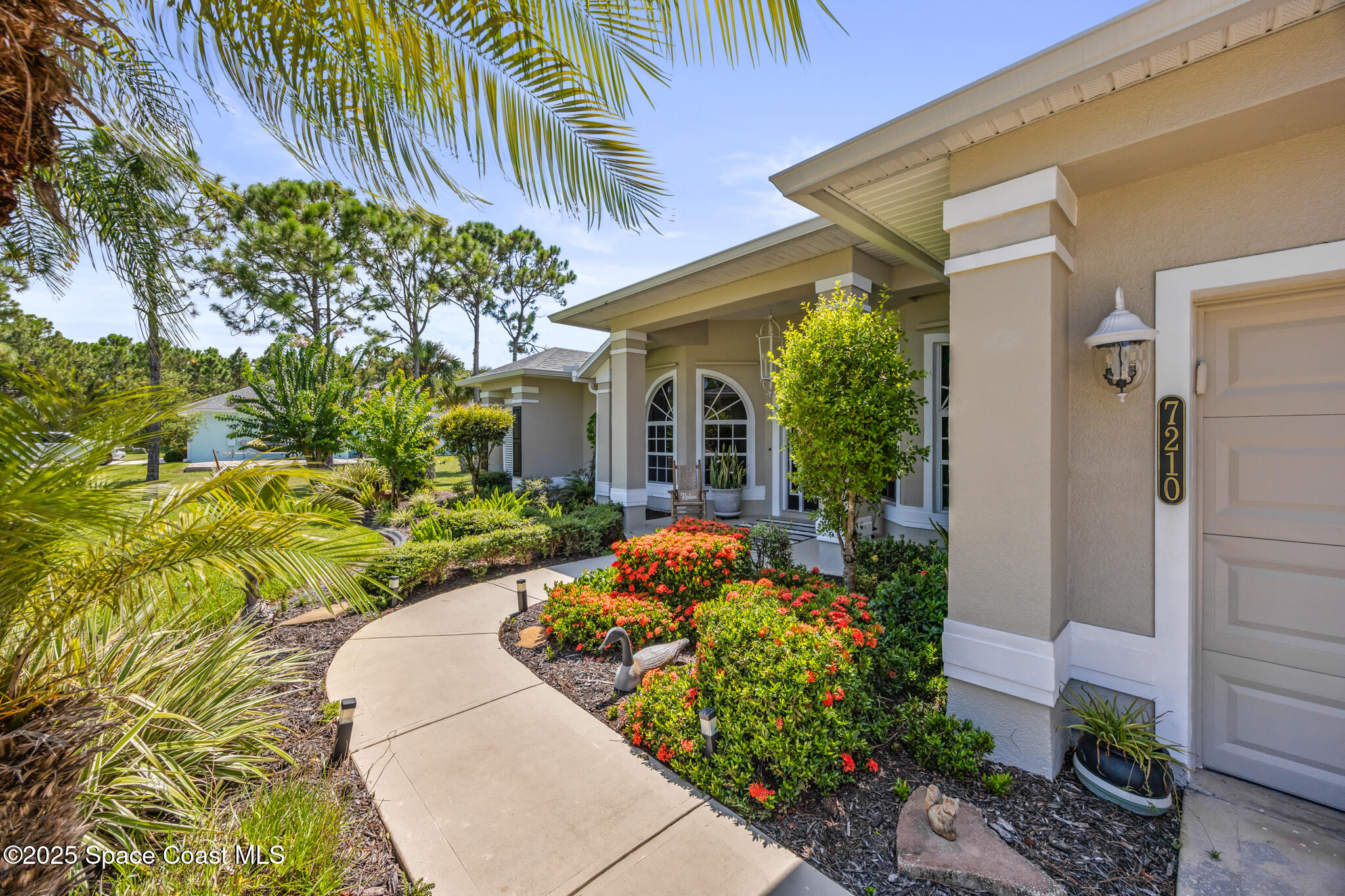 7210 Wando Avenue Grant, FL 32949 - Photo 3 of 41 a front view of a house with a yard