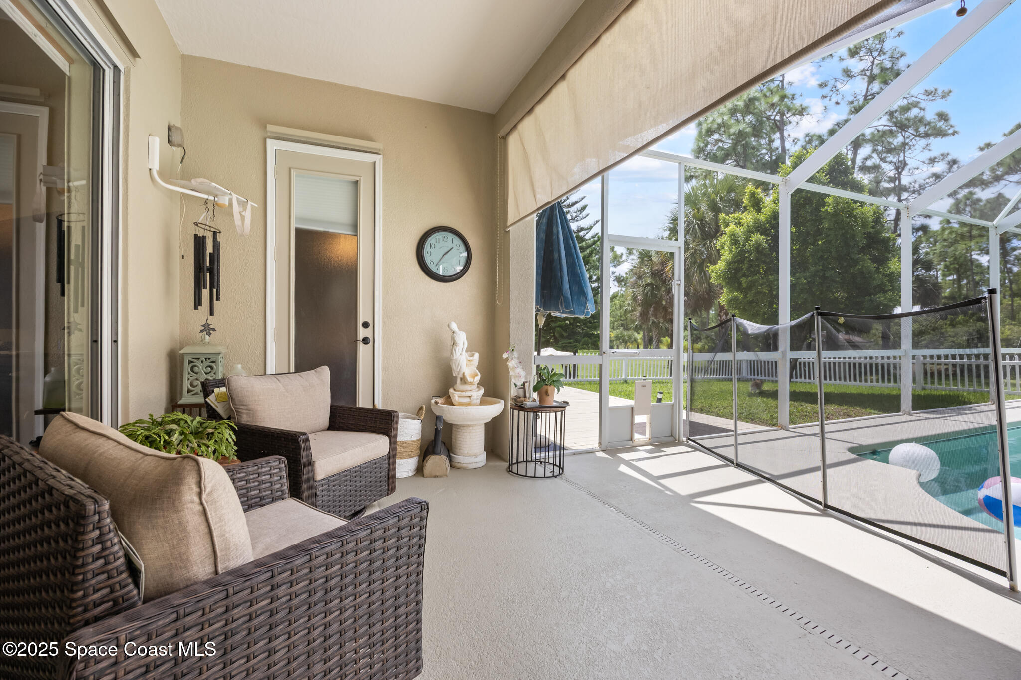 7210 Wando Avenue Grant, FL 32949 - Photo 32 of 41 a living room with furniture and a large window with outer view