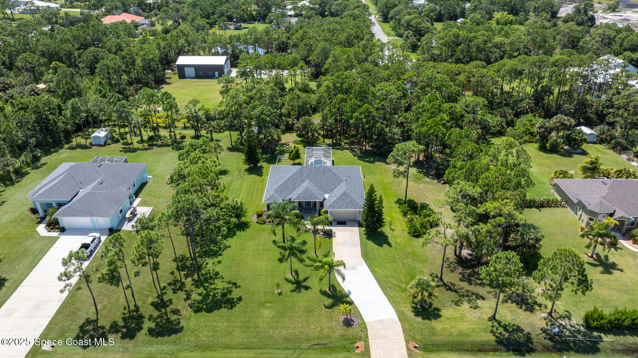 7210 Wando Avenue Grant, FL 32949 - Photo 40 of 41 an aerial view of residential house with outdoor space and trees all around