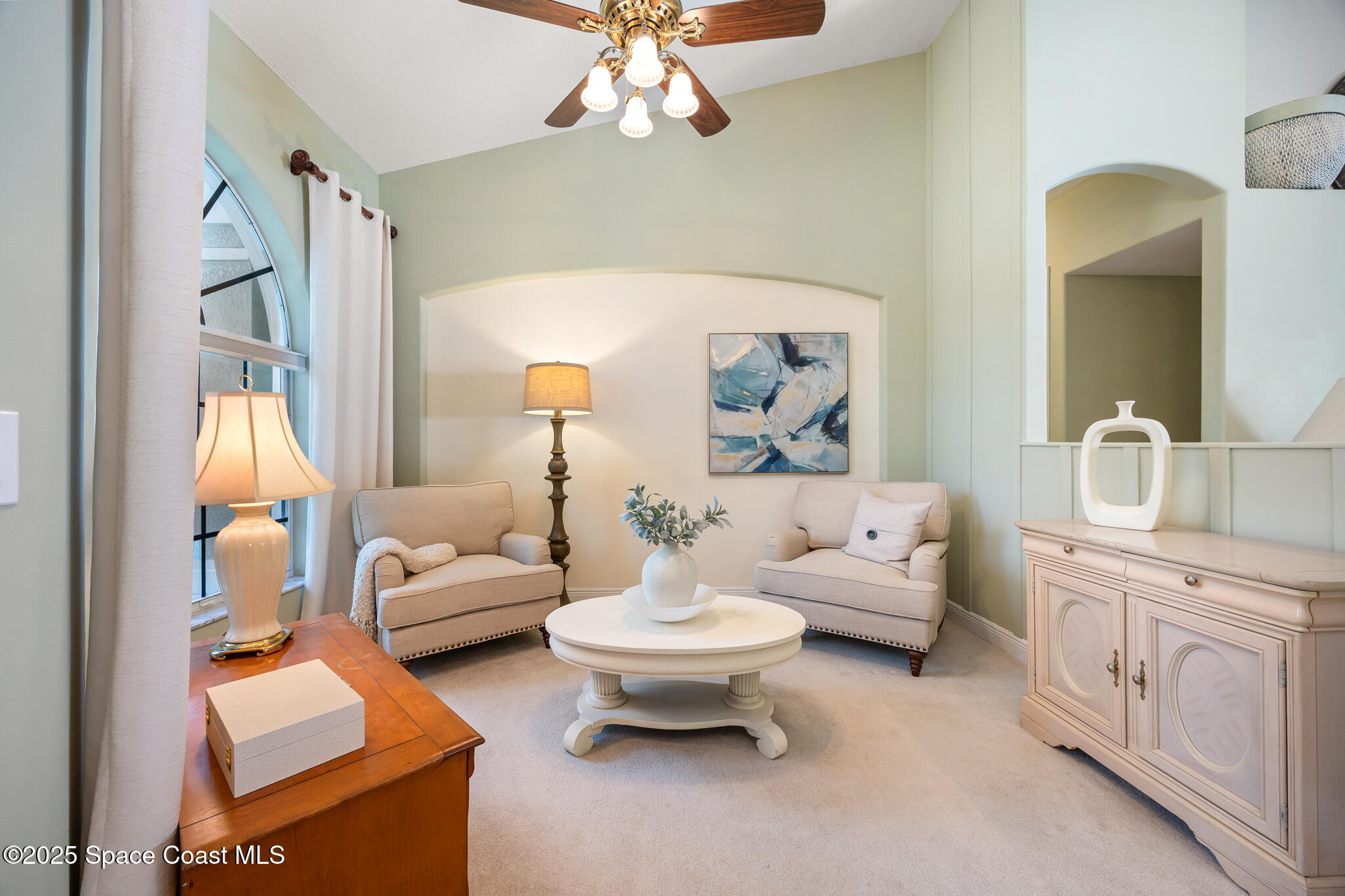 7210 Wando Avenue Grant, FL 32949 - Photo 5 of 41 a living room with furniture and a chandelier