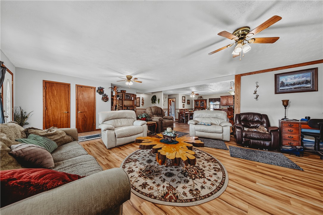21587 West Hickory Flat Road Springdale, AR 72764 - Photo 13 of 45 Spacious main living area flows into the dining room and kitchen, providing a flexible layout for everyday living and entertaining.
