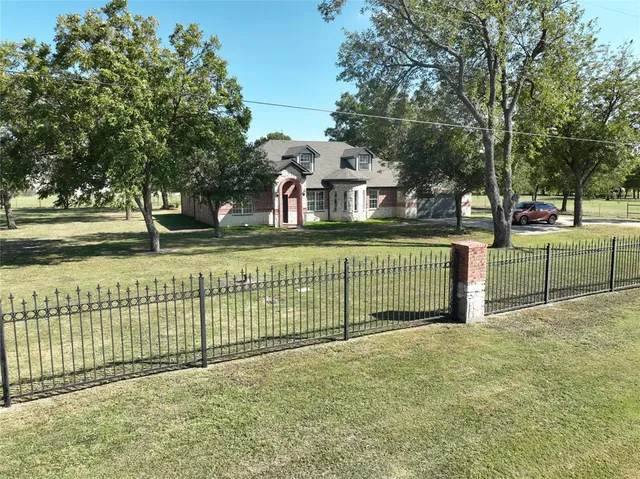 a front view of a house with a fence