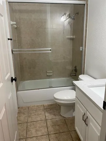 a bathroom with a toilet a sink and shower