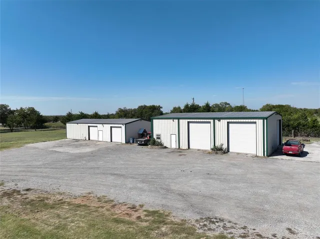 a view of a house with a yard and garage