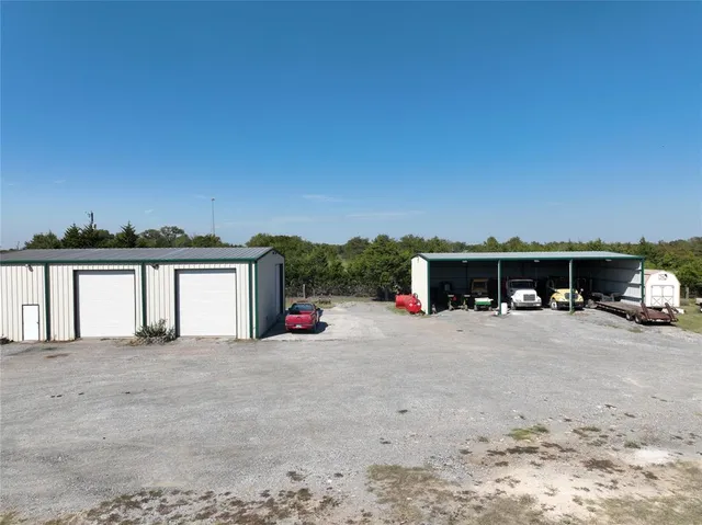 a view of a house with large space and large trees