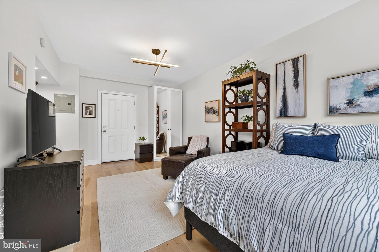 1701 16th Street Northwest, Unit 710 Washington, DC 20009 - Photo 16 of 30 a bedroom with a bed and a flat screen tv