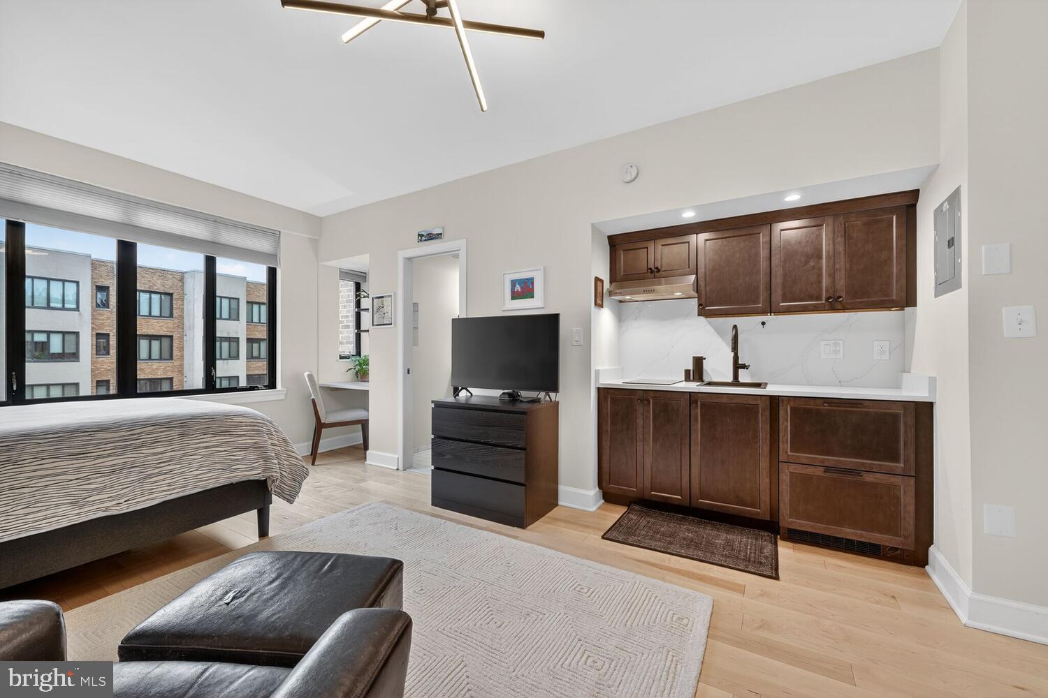 1701 16th Street Northwest, Unit 710 Washington, DC 20009 - Photo 8 of 30 a living room with furniture and a flat screen tv