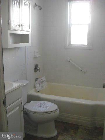 406 Old Home Road Baltimore, MD 21206 - Photo 10 of 11 a bathroom with a toilet and a bathtub