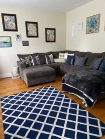 30-32 Beaconsfield Road Worcester, MA 01602 - Photo 4 of 10 a living room with a black white checkered floor with a black white checkered floor