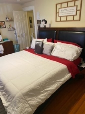 30-32 Beaconsfield Road Worcester, MA 01602 - Photo 7 of 10 a bedroom with a bed and wooden floor