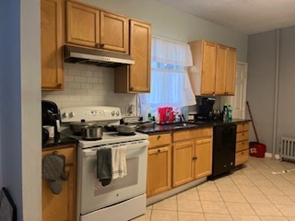 30-32 Beaconsfield Road Worcester, MA 01602 - Photo 8 of 10 a kitchen with stainless steel appliances granite countertop a sink stove and cabinets