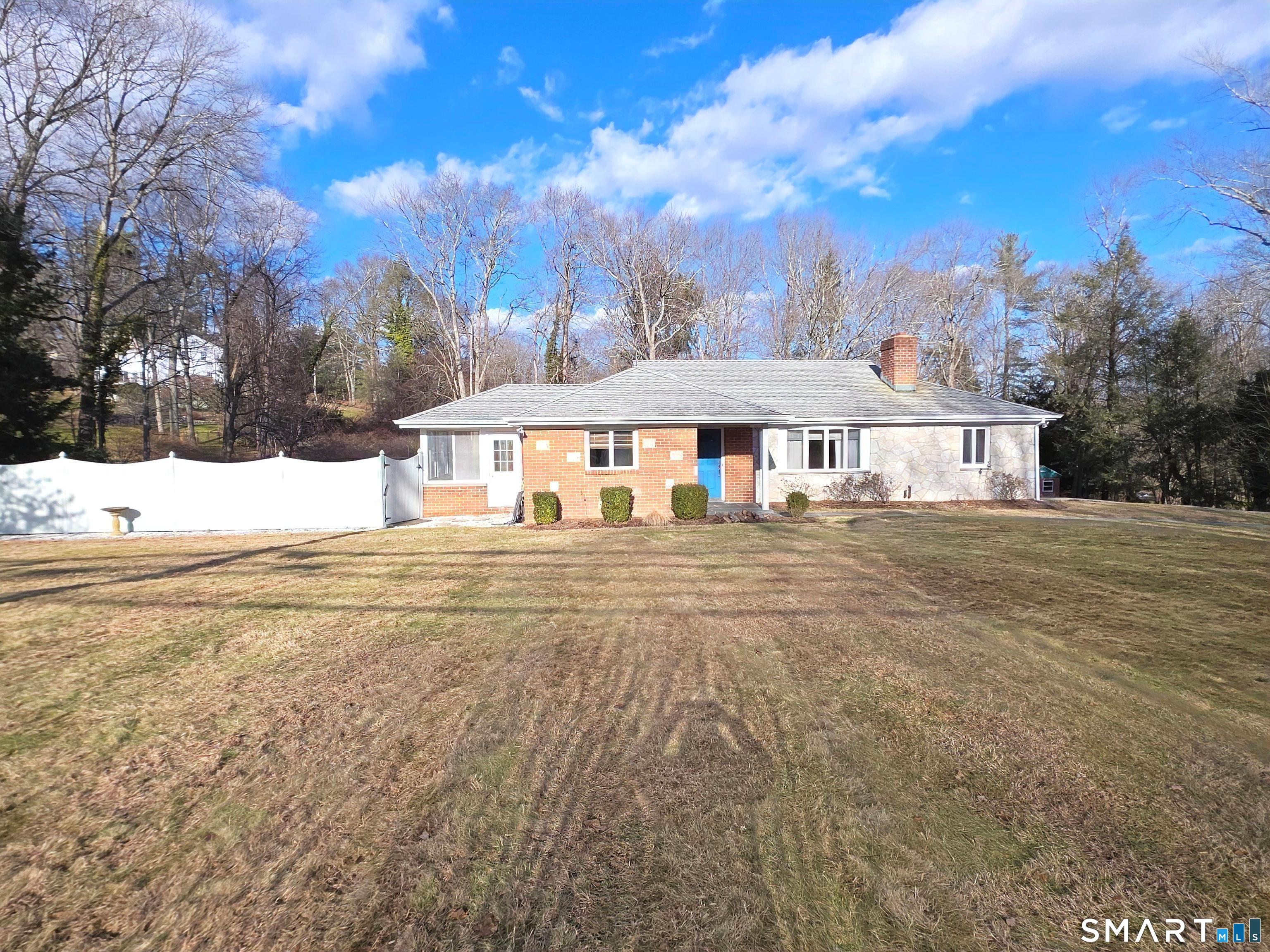a view of a house with yard and sitting area