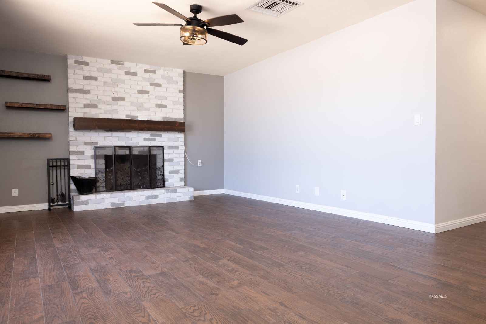 542 South Warner Street Ridgecrest, CA 93555 - Photo 6 of 33 a view of a livingroom with a fireplace and a chandelier fan