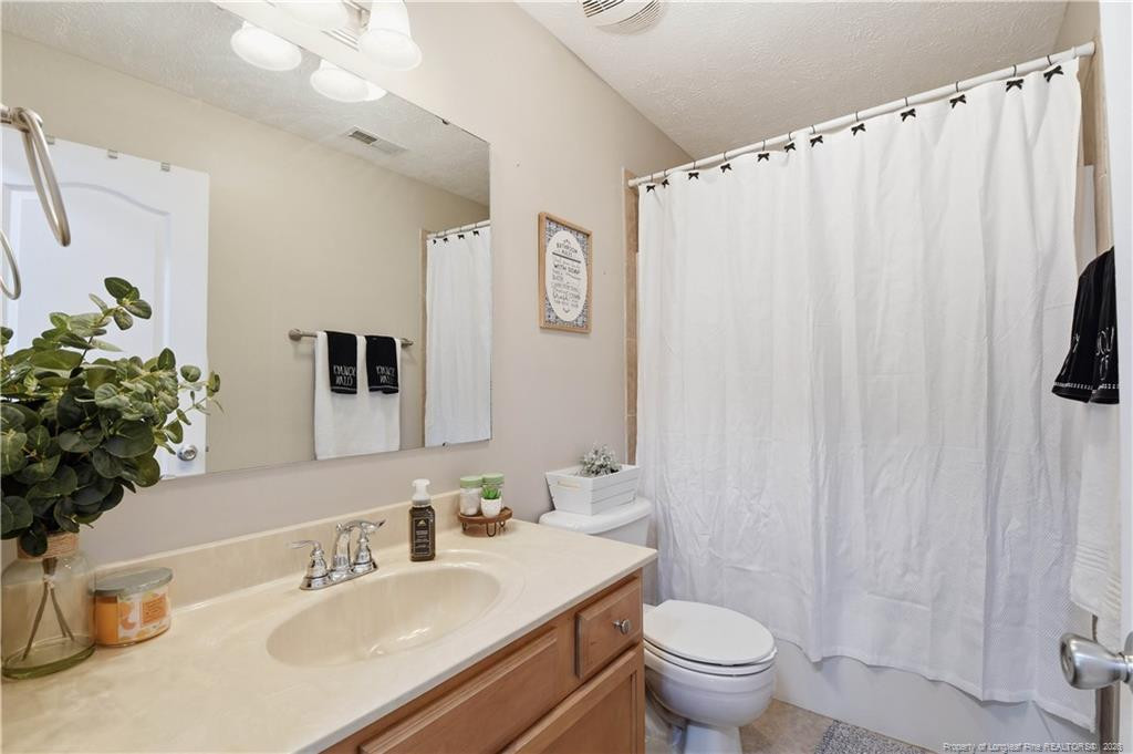212 Lennox Loop Raeford, NC 28376 - Photo 24 of 47 a bathroom with a sink toilet and shower