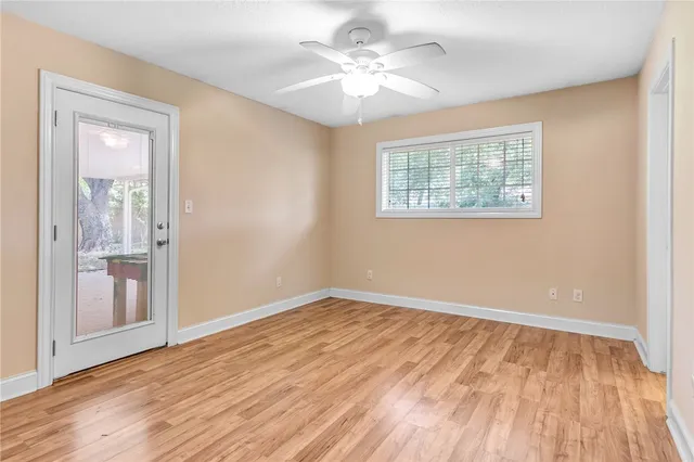 wooden floor in an empty room with a window