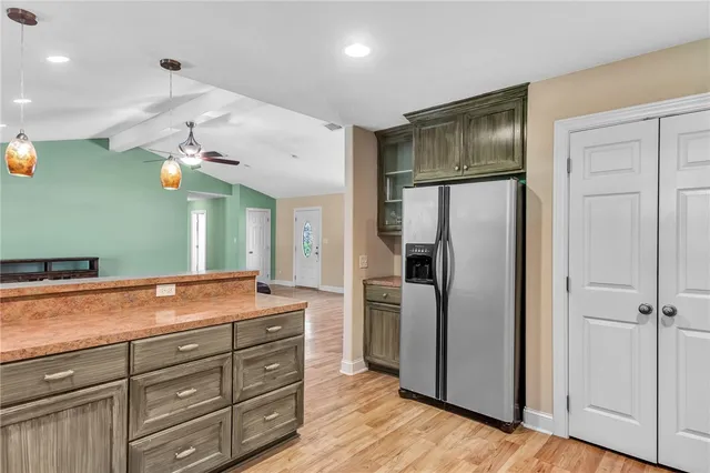 a kitchen with a refrigerator and a sink