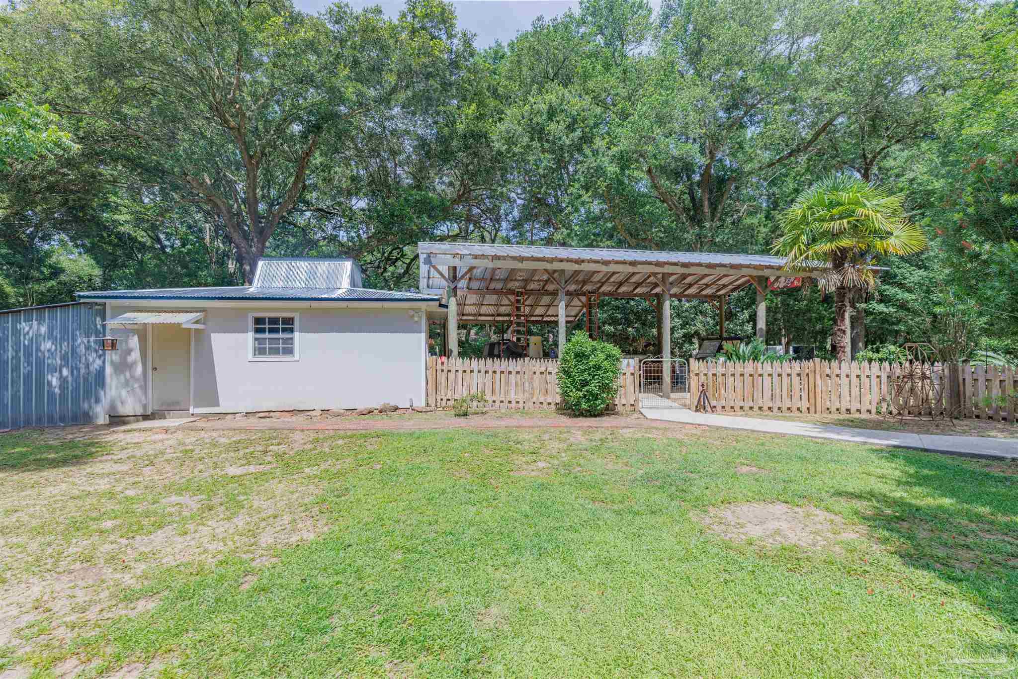 5049 Guernsey Road Pace, FL 32571 - Photo 57 of 61 front view of a house with yard and deck