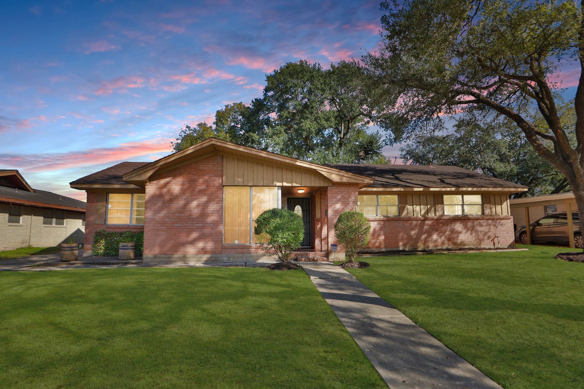 a front view of house with yard and green space