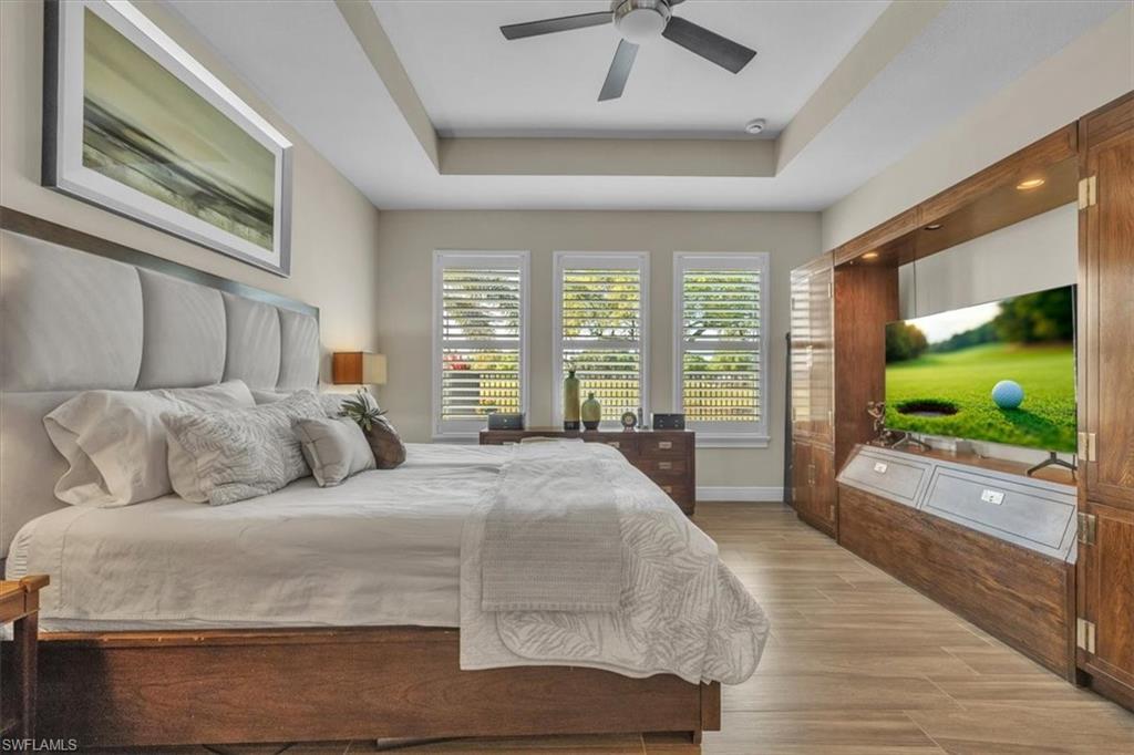 16424 Windsor Way Alva, FL 33920 - Photo 18 of 50 a living room with a large bed and a flat tv screen on dresser