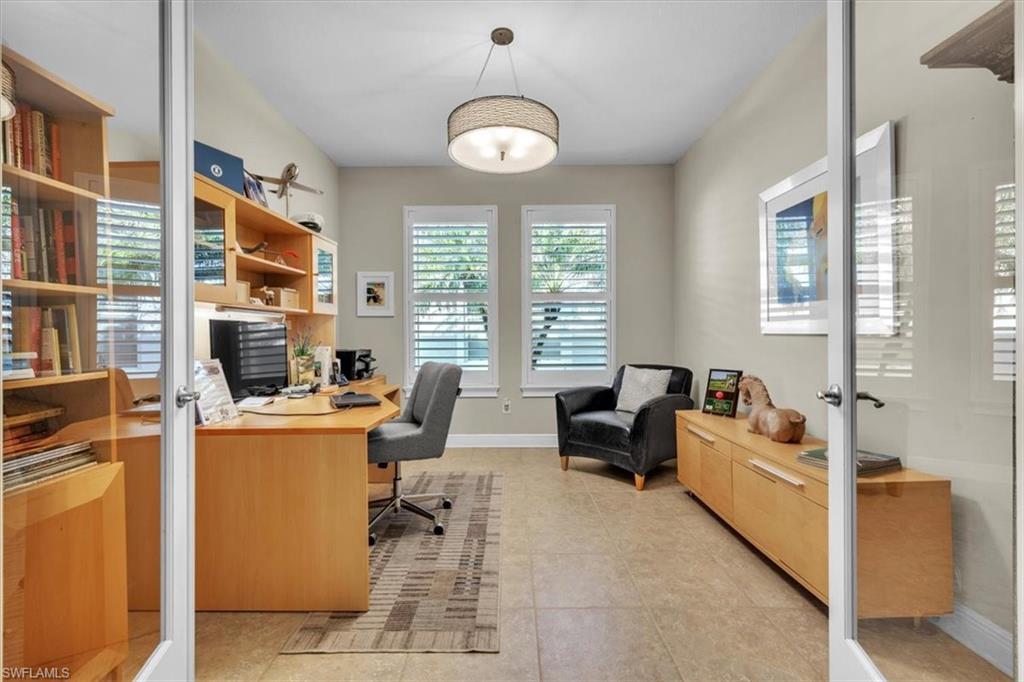 16424 Windsor Way Alva, FL 33920 - Photo 24 of 50 a living room with furniture a flat screen tv and a window