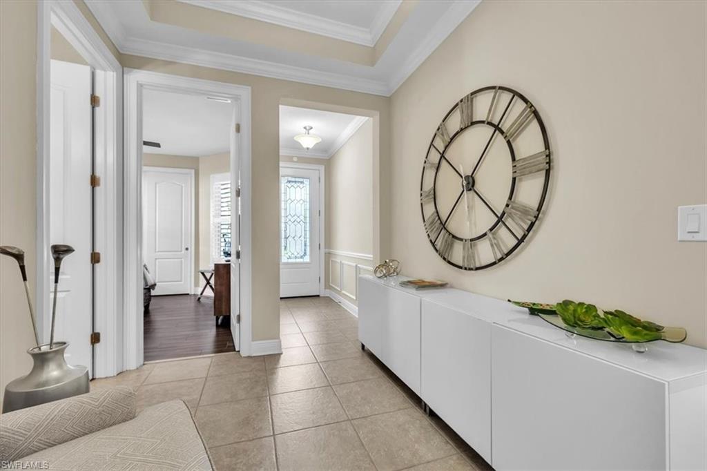 16424 Windsor Way Alva, FL 33920 - Photo 8 of 50 a hallway with a large mirror and a wooden floor