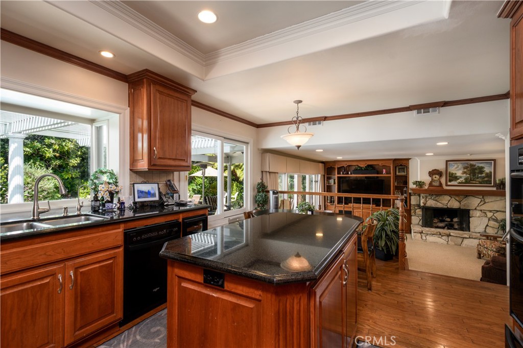 3001 Valera Fullerton, CA 92835 - Photo 11 of 25 a kitchen with kitchen island granite countertop a sink stove and cabinets
