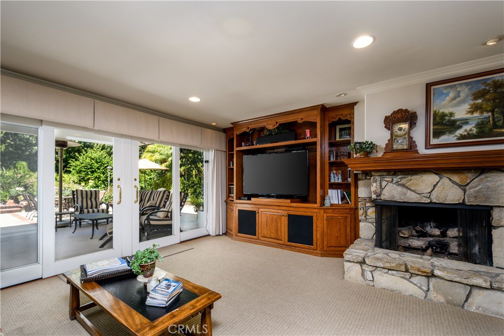 3001 Valera Fullerton, CA 92835 - Photo 12 of 25 a living room with furniture a flat screen tv and a fireplace