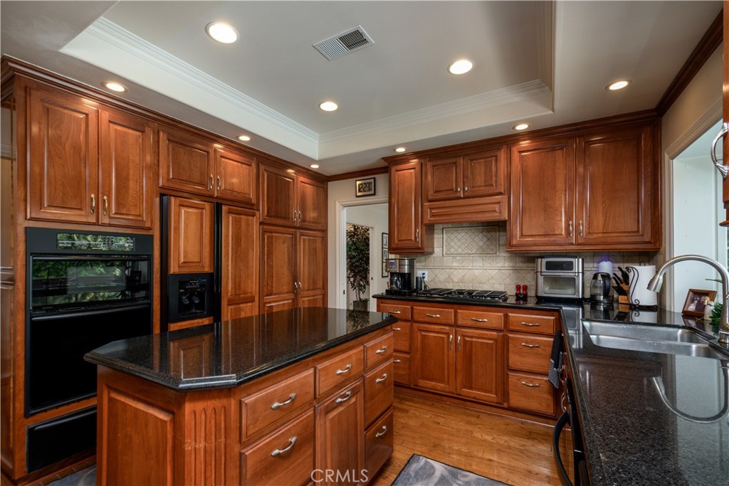 3001 Valera Fullerton, CA 92835 - Photo 10 of 25 a kitchen with kitchen island granite countertop counter top space a sink stainless steel appliances and cabinets