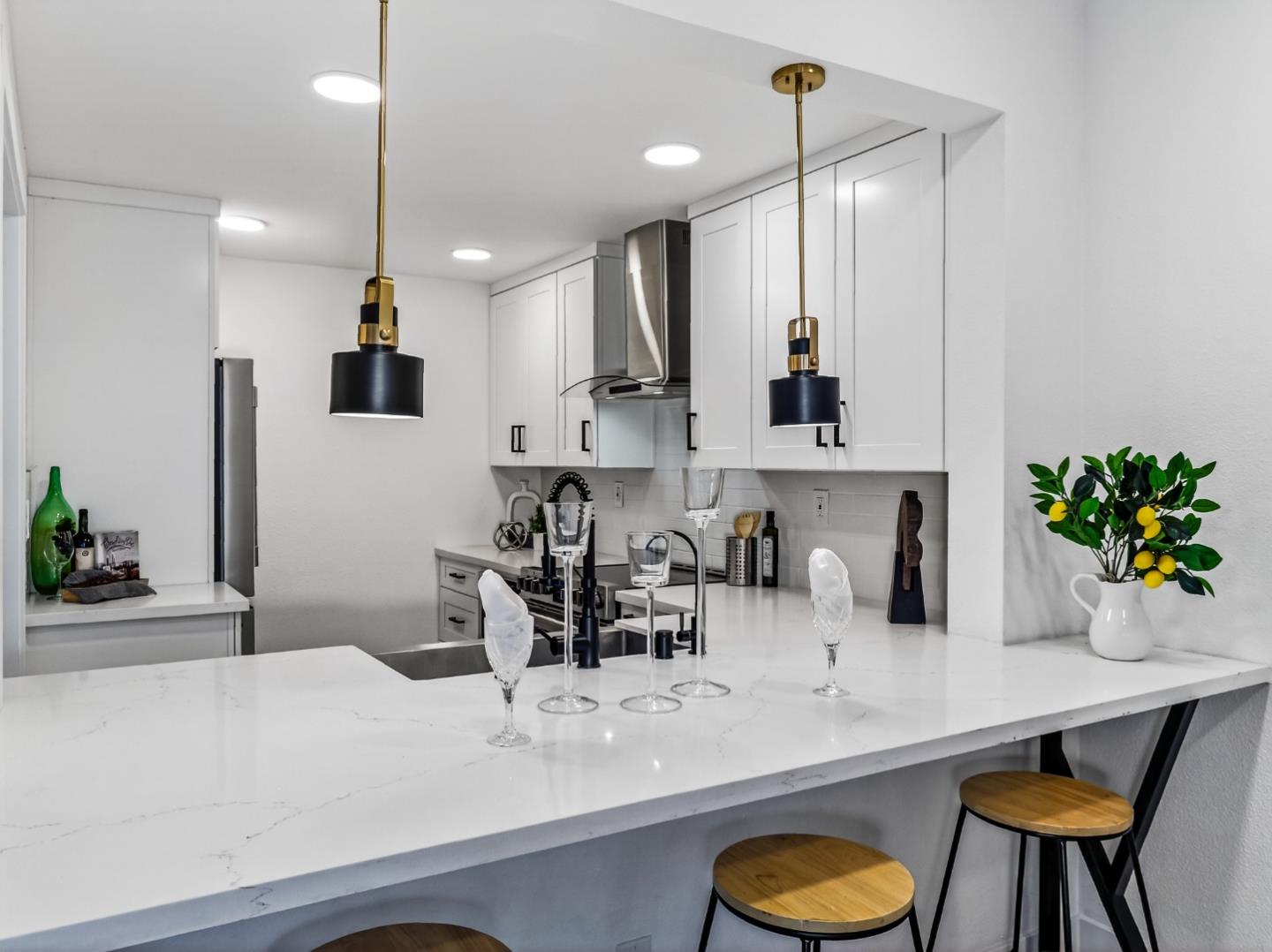 2084 Foxhall Loop San Jose, CA 95125 - Photo 12 of 44 a kitchen with kitchen island a sink and a refrigerator