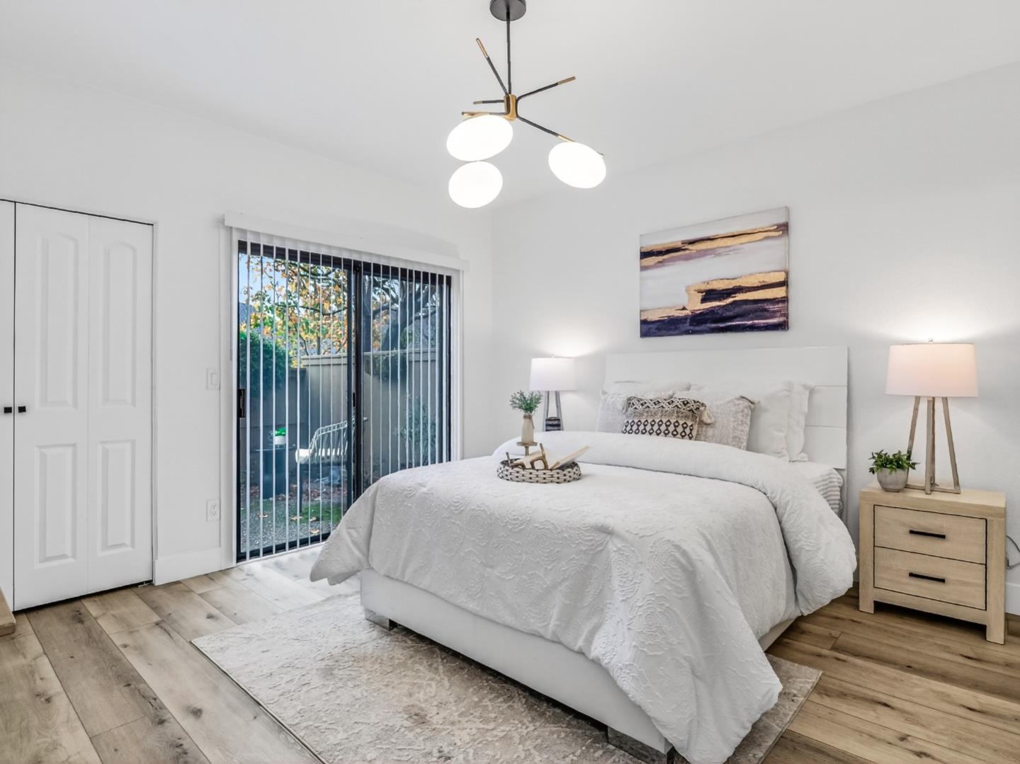 2084 Foxhall Loop San Jose, CA 95125 - Photo 27 of 44 a bedroom with a bed and a chandelier