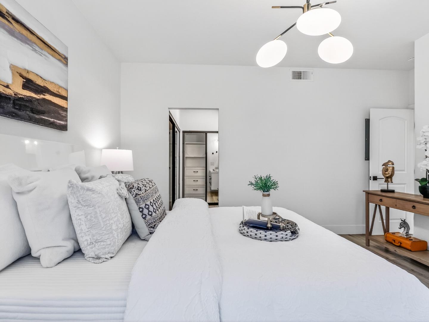 2084 Foxhall Loop San Jose, CA 95125 - Photo 30 of 44 a bedroom with a bed and a chandelier