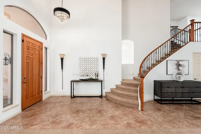 a living room with furniture a fireplace and a large window