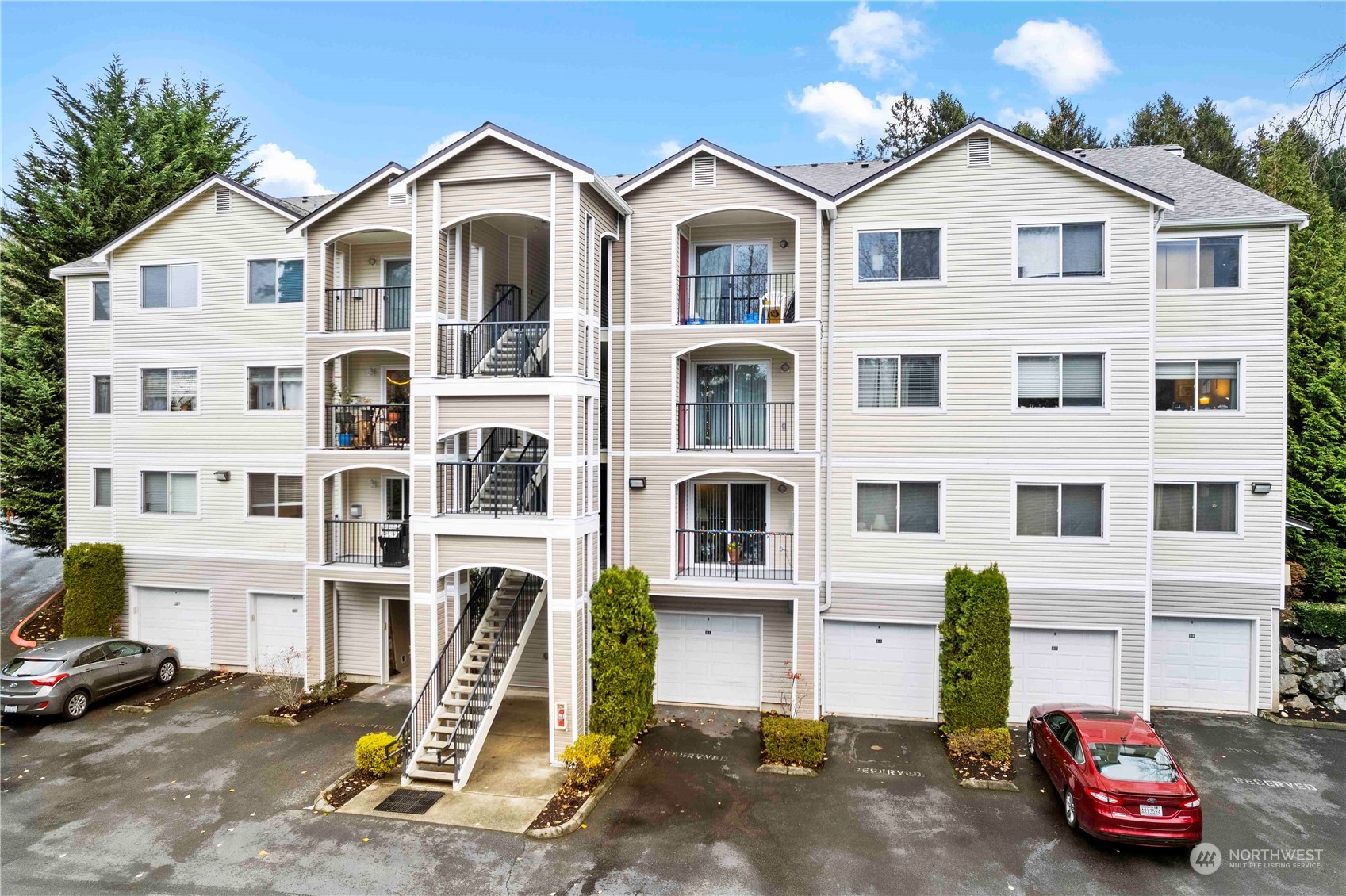 10709 Valley View Road, Unit B302 Bothell, WA 98011 - Photo 1 of 20 a car parked in front of a white house