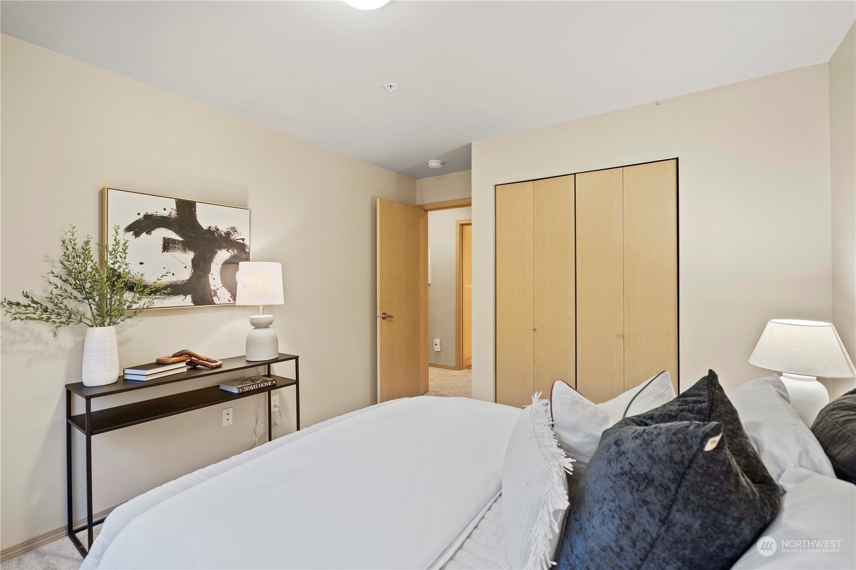 10709 Valley View Road, Unit B302 Bothell, WA 98011 - Photo 13 of 20 a bedroom with a bed and wooden floor