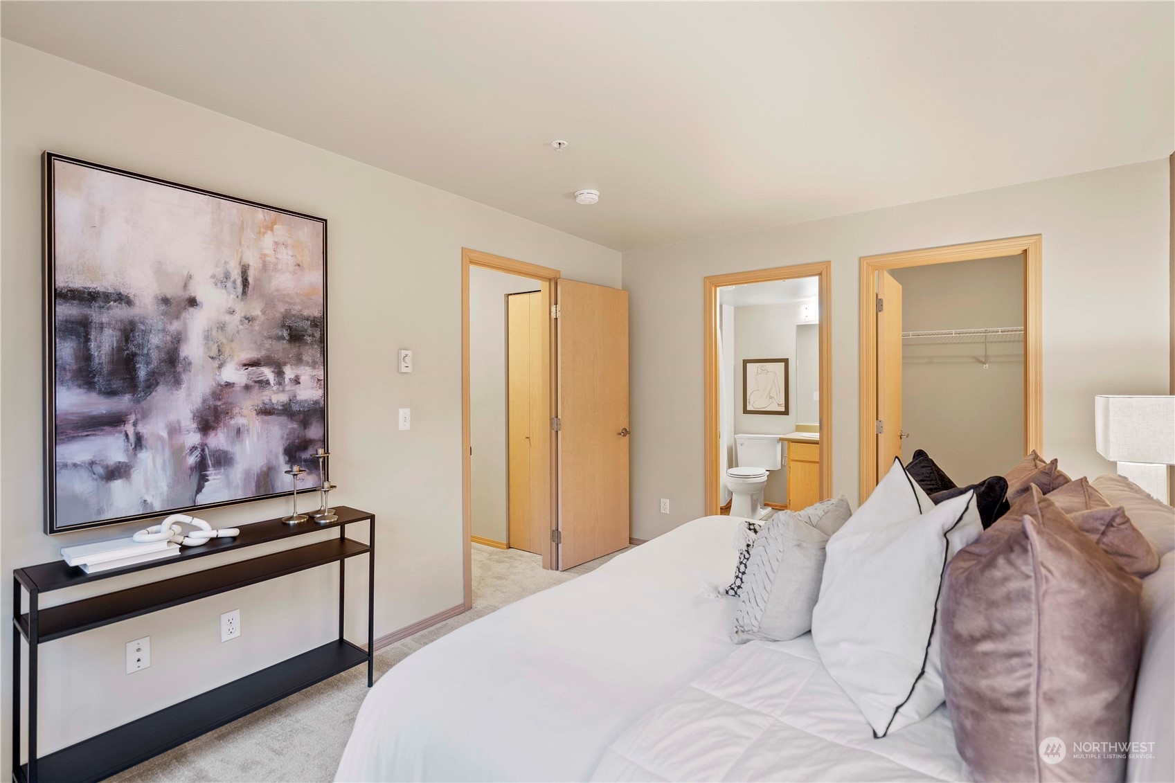 10709 Valley View Road, Unit B302 Bothell, WA 98011 - Photo 15 of 20 a bedroom with a bed and painting on the wall