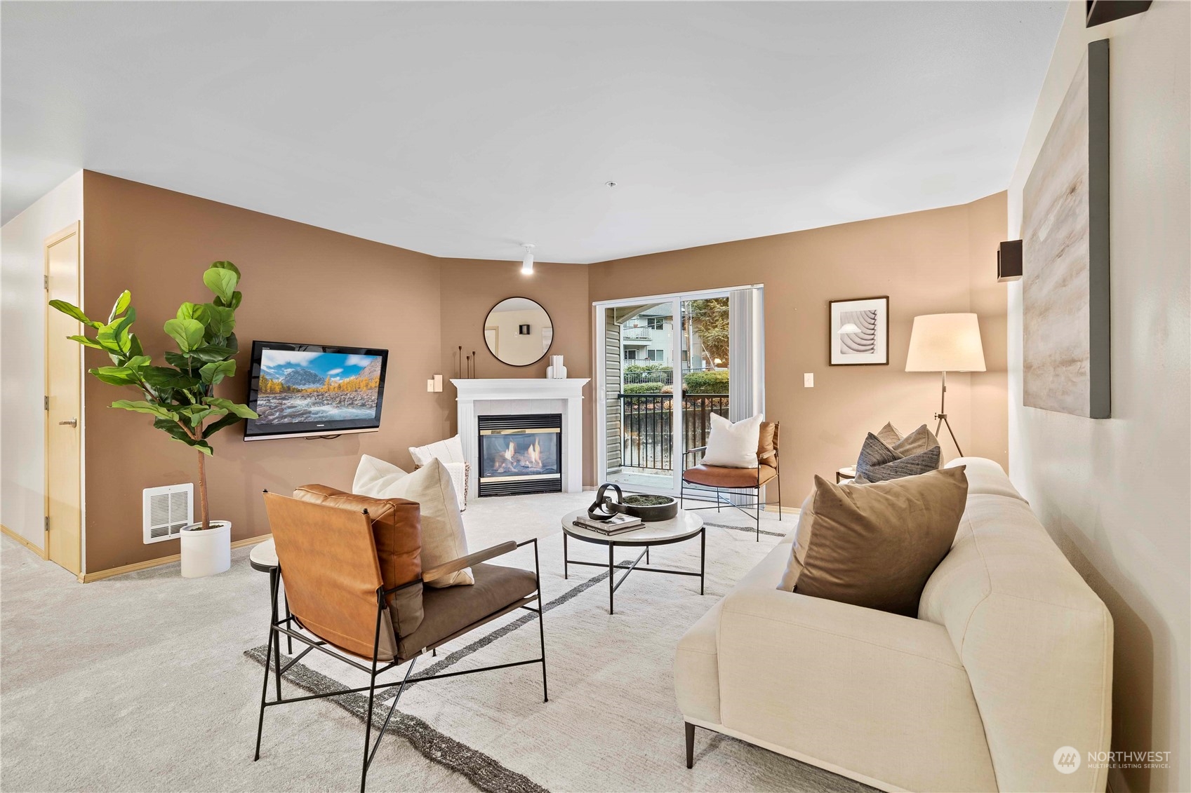 10709 Valley View Road, Unit B302 Bothell, WA 98011 - Photo 3 of 20 a living room with furniture a fireplace and a flat screen tv