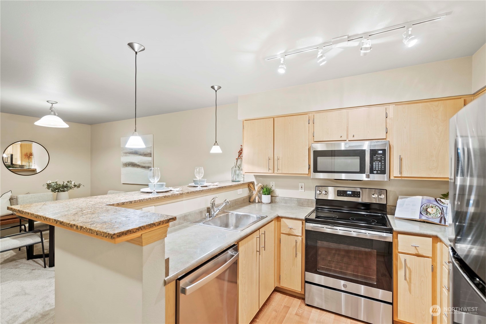 10709 Valley View Road, Unit B302 Bothell, WA 98011 - Photo 8 of 20 a kitchen with a stove a sink and a refrigerator