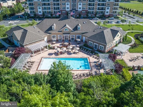 an aerial view of a house with garden space and swimming pool