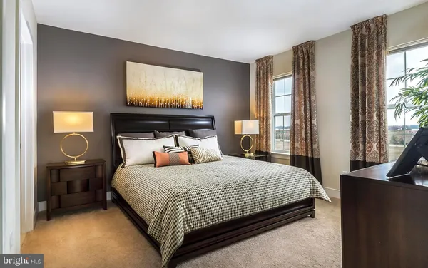 a bedroom with a bed and glass window