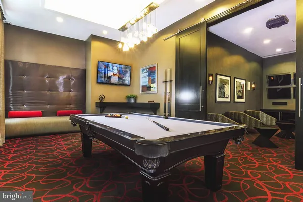 a room with pool table and wall paintings