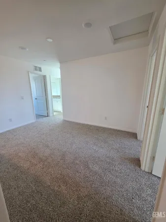 a view of an empty room and a window