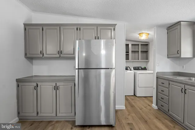 a kitchen with stainless steel appliances granite countertop a sink a stove and a microwave