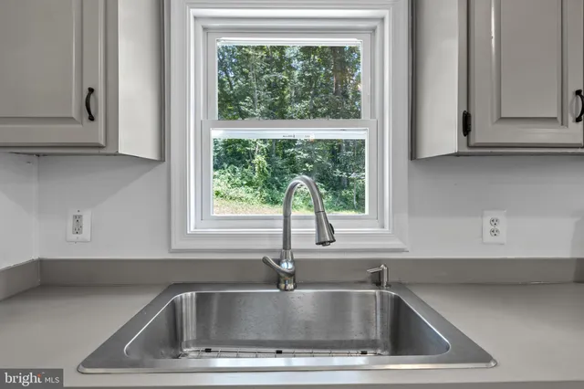 a kitchen with cabinets and stainless steel appliances
